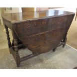 A Large Oak Gateleg Table, circa 19th century, raised on turned legs and adjoining stretchers, one