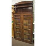 A Victorian Mahogany Bookcase, with added Victorian mahogany chiffonier top, above two glazed
