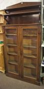A Victorian Mahogany Bookcase, with added Victorian mahogany chiffonier top, above two glazed