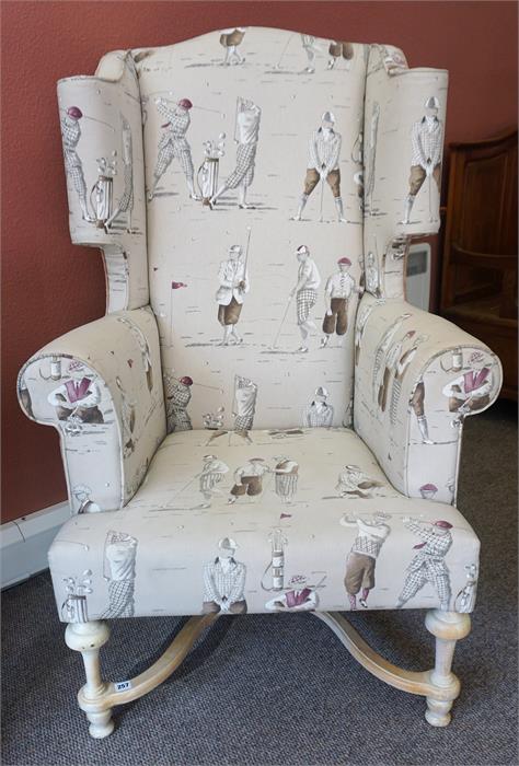 A Modern William & Mary Style Wing Armchair, Upholstered in a cream coloured golfing theme, 134cm