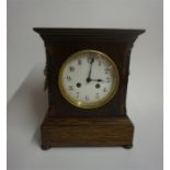 A Late Victorian Oak Mantel Clock, the French twin train movement is striking on a gong, with gilt