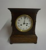 A Late Victorian Oak Mantel Clock, the French twin train movement is striking on a gong, with gilt