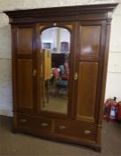 A Victorian Style Mahogany Inlaid Wardrobe, with a moulded cornice above a glazed pivot door,