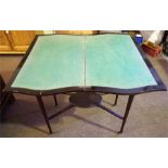 An Edwardian Mahogany Fold Over Card Table, enclosing a green felt lined interior, raised on tapered