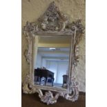 A French Style Painted Wall Mirror, with moulded scroll and floral decoration, 137cm high, 83cm
