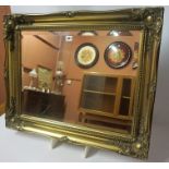 A Gilt Framed Bevelled Glass Wall Mirror, 61cm high, 76cm wide