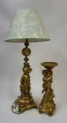 A Gilt Metal & Onyx Table Lamp, Modelled as a nude Putti child, 50cm high, with shade, fitted for
