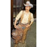 A Large Resin Figure of a Cowboy, With moulded signature to the reverse for Universal, dated 1985,