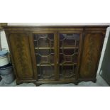 A Mahogany Breakfront Bookcase, with two glazed astragal doors enclosing a shelved interior, flanked