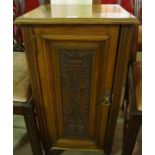 A Late Victorian Mahogany Pot Cupboard, With a carved panelled door enclosing a shelved interior,