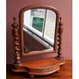 A Victorian Mahogany Dressing Mirror, the swing mirror is raised on two barley twist column