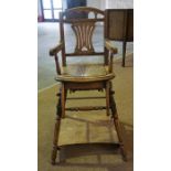 An Edwardian Metamorphic Child,s Feeding Chair, the chair folds to form a play pen seat on wheels,