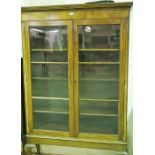 A Mahogany Display Cabinet, with two glazed doors enclosing a shelved interior, raised on cabriole