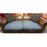 A Tan Leather Three Seater Chesterfield Sofa, with fabric covered seats and cushions, 70cm high,