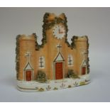 A 19th Century Staffordshire Pottery Spill Holder, in the form of a cathedral with clock face,