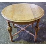 An Oak Coffee Table, the circular top is raised on turned and reeded legs, with adjoining under