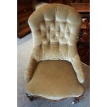 A Victorian Walnut Gossip Chair, Upholstered in button back velour, with serpentine shaped seat,
