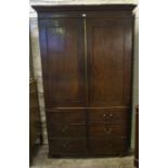 An Antique Mahogany Wardrobe, With two panelled doors, with faux drawers, enclosing a hanging