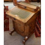 A Victorian Figured Walnut Inlaid Davenport Desk, With a hinged stationery compartment to the top,