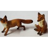 Two Beswick Porcelain Fox Figures, In the form of a seated and standing fox, 7cm high, (2)