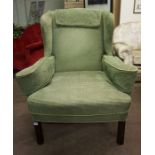 A Pair of Wing Armchairs by David South, Upholstered in green fabric, raised on chamfered legs,