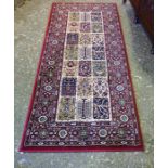 A Small Valby Ruta Machine Made Rug, Decorated with geometric symbols to the centre, with floral