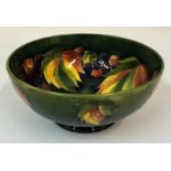 A William Moorcroft Leaf & Berries Pattern Fruit Bowl, Glazed in green, raised on a circular foot,