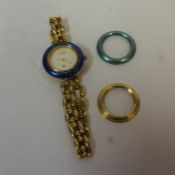 A Genuine Gucci Ladies Wristwatch, on a yellow metal flexible bracelet, with two spare bezels, in