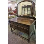 A Jacobean Style Oak Dressing Table, with swing mirror above two small drawers and long drawer,