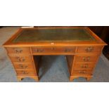 A Large Modern Yewwood Kneehole Desk, with a tooled green and gilt leather skiver to the top,