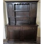 An Oak Dresser, with open shelving, flanked with a panelled door, above a cupboard base, 200cm high,