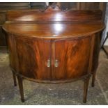 A Mahogany Demi-Lune Cabinet, With pediment above two doors enclosing shelved interior and