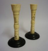 A Pair of Japanese Ivory Candlesticks, Meiji Period, Decorated with carved panels of figures, raised
