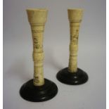 A Pair of Japanese Ivory Candlesticks, Meiji Period, Decorated with carved panels of figures, raised