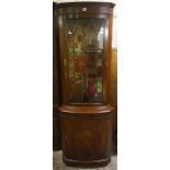 A Reproduction Corner Cabinet, With a glazed door enclosing a shelved interior, above a panelled