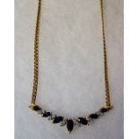 An 18ct Gold Sapphire & Diamond Chain, With seven graduated sapphire stones, approximately 1 carat