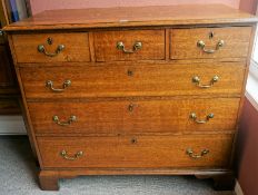 A George III Oak Chest of Drawers, with three small drawers above three long drawers, raised on