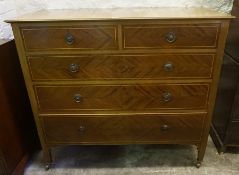 A Mahogany Inlaid Chest of Drawers, With two small drawers above three long drawers, stamped to