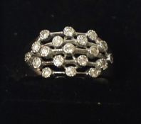 An 18ct White Gold & Diamond Dress Ring, With nineteen small diamond stones to the centre,
