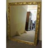 A Large Modern Gilt Framed Wall Mirror, with moulded panels of leafs and fruit vines to the frame,