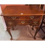 A Georgian Style Walnut Lowboy, With a drawer above three assorted smaller drawers, raised on