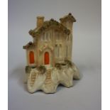 A 19th Century Staffordshire Pottery Quill Holder, in the form of a house, 13cm high