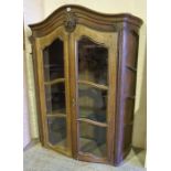 An Antique Continental Oak Display Cabinet, with two glazed doors enclosing a fitted interior,