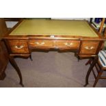 An Edwardian Ladies Walnut Desk, With a tooled leather skiver above a long drawer, flanked by a