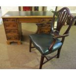 A Victorian Mahogany Kneehole Desk, with a later tooled leather top above a drawer, flanked by