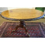 A Victorian Walnut Loo Table, Decorated with inlaid floral panels to the oval top, raised on a