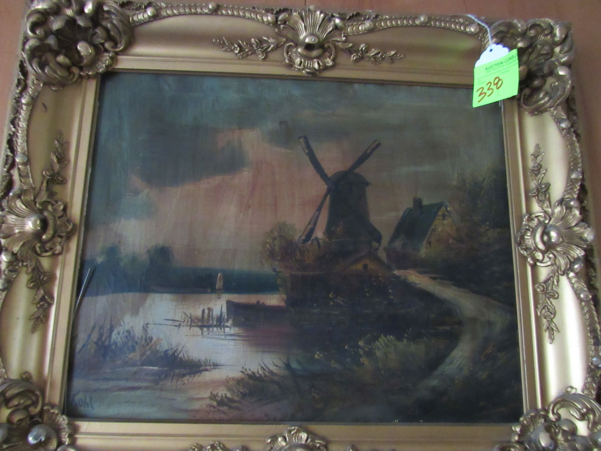 Oil on canvas, windmill cottage and lake, artist signed lower left Kohl, in a carved gilt wood frame