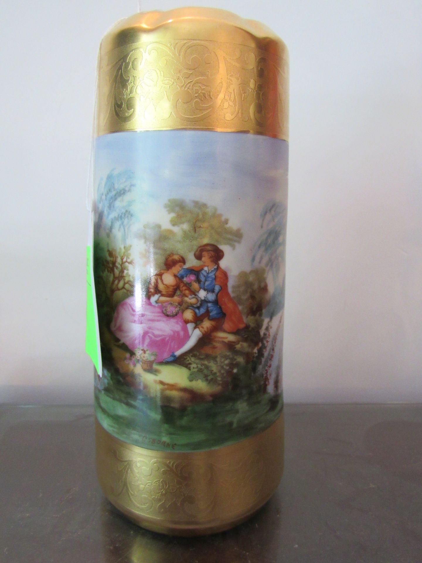 Bavarian hand painted vase depicting couple in landscape, signed Osborne, height 8”