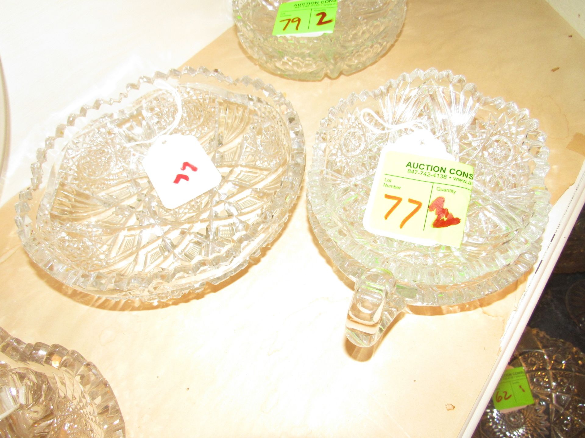 Three cut glass bowls, one with handle