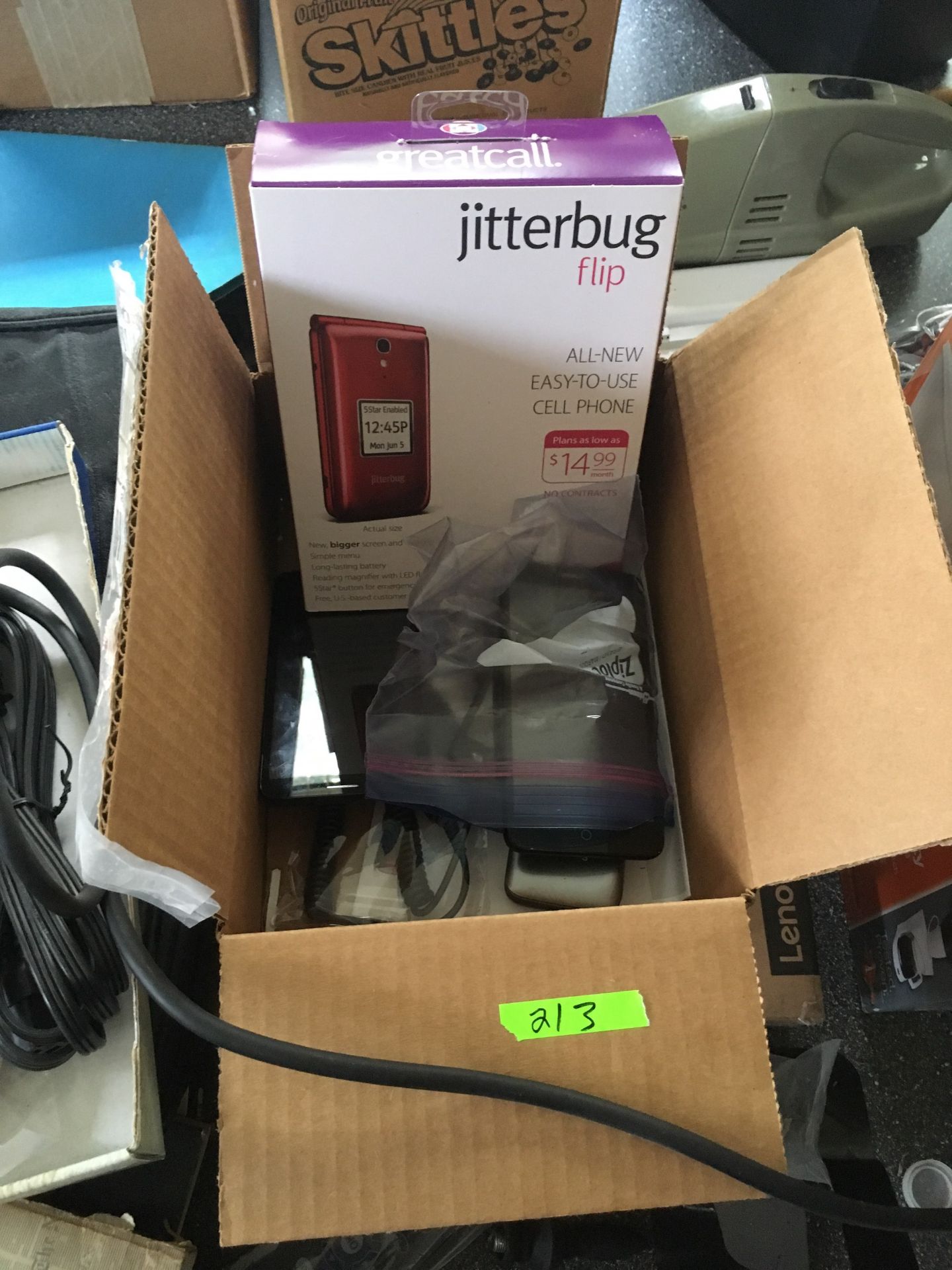 Group of used cell phones and a new jitterbug in box
